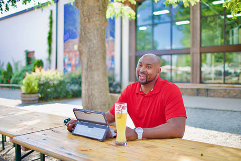 man professional working at outdoor brewery smiling