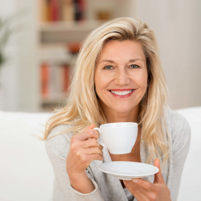 Blond woman holding coffee