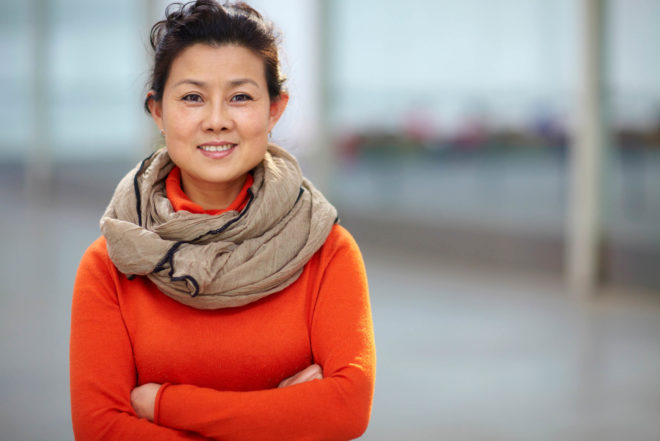 Asian woman orange shirt